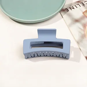 Detailed macro view of large matte Morandi blue claw clip with hollow geometric design