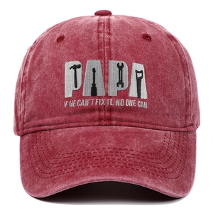 Close-up of PAPA embroidery with tool silhouettes on vintage washed red baseball cap