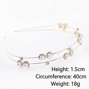 Elegant gold metal headband with white pearls and rhinestones on a white background