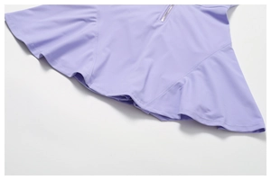 Detail of lavender athletic dress hem showing smooth fabric and metallic zipper closure