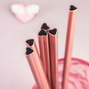 Five heart-shaped rose gold stainless steel straws for cups with a romantic pink aesthetic