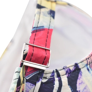 Macro shot of abstract graffiti print strap and silver metal buckle on baseball cap