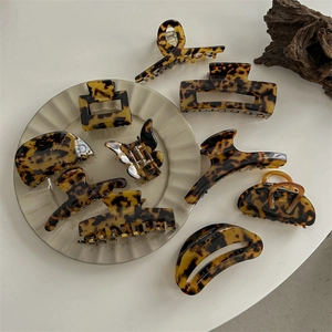 Collection of large acetate hair claws in dark leopard print and tortoiseshell patterns