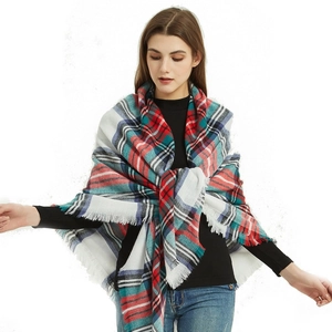 Close-up detail of soft cashmere-like multi-color plaid scarf with elegant fringe edges