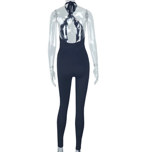 Back view of a black halter backless jumpsuit on a mannequin with tight fit design