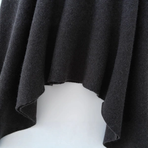 Women's black asymmetrical cape coat with premium knitted texture and flowing hem design