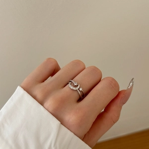 Detailed view of S925 silver star and moon ring with cubic zirconia on a hand