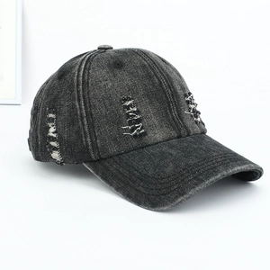 Detailed side view of a black washed denim baseball cap featuring distressed ripped effects
