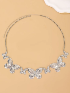 Detail of silver butterfly body chain featuring metallic charms and adjustable lobster clasp