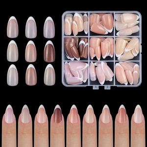 Detail of mixed nude and brown French manicure tips set with white tips in storage box