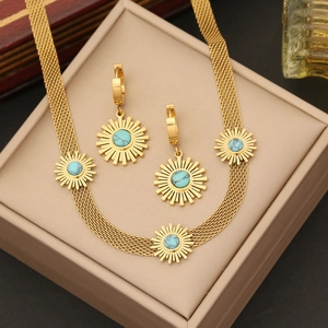 Golden sunburst jewelry set with turquoise stones and mesh chain in a gift box