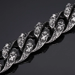 Macro detail of antique silver lion head links on a heavy vintage steel bracelet