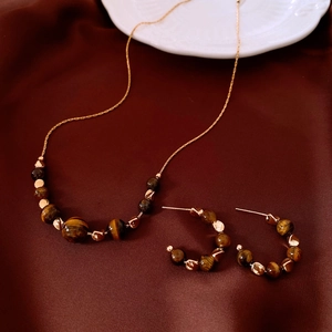 18k gold plated tiger eye necklace and earrings jewelry set on red silk background