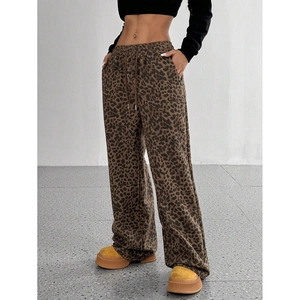 Detail of trendy leopard print wide-leg pants featuring a high-waist elastic drawstring band