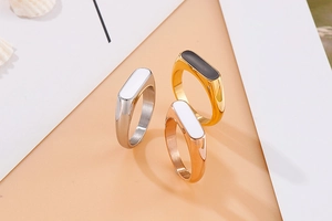 Detailed view of oval stainless steel rings with black and white resin inlays