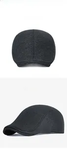 Detail view of winter wool herringbone flat cap with close-up of thick fabric texture