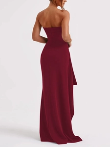 Detail of burgundy off-shoulder evening dress showing the backless cut and side slit