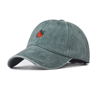 Detailed close-up of dark green washed cotton baseball cap with red strawberry embroidery