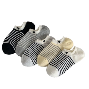 Five pairs of striped low cut socks in neutral colors with small heart heart details
