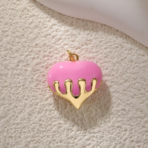 Detailed view of a pink enamel heart pendant with molten gold drip effect metalwork