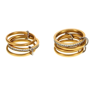 Multilayer gold stainless steel rings with sparkling cubic zirconia on white background