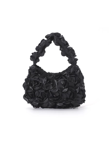 Detailed view of 3D satin rose flowers on a black crescent-shaped evening handbag