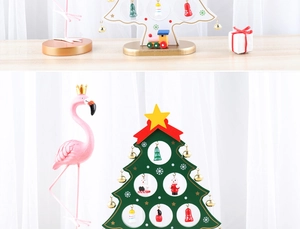 Close-up of wooden Christmas tree tabletop decor with miniature painted ornaments and train