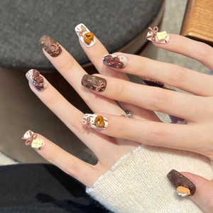 3D dessert themed press-on nails with chocolate bows and cookies on short square tips