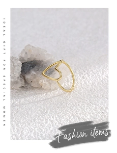 Detailed close-up of a gold hollow heart ring displayed on a natural crystal cluster