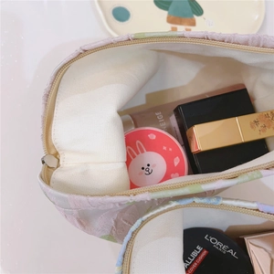Close-up of floral canvas makeup bag interior with spacious storage and cream lining