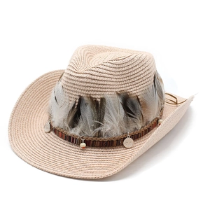 Detail of woven straw cowboy hat featuring natural feathers and silver metal accents