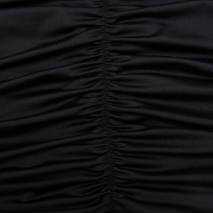 Macro view showing the textured ruched fabric and elastic material of the black dress