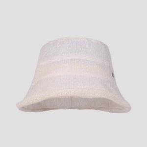 Close-up of beige bouclé bucket hat featuring textured fabric and small metal logo detail