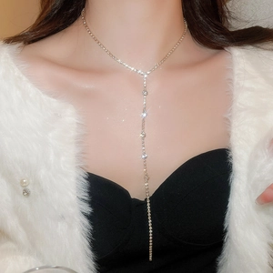 Detailed view of elegant sparkling rhinestone fringe lariat necklace on model