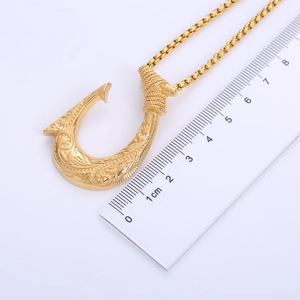 Detail view of gold Viking fish hook pendant with scale showing 4cm height dimension