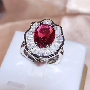 Elegant silver ring with oval red gemstone and radiant crystal halo design for women