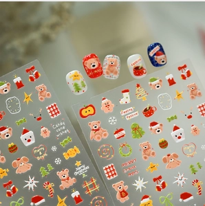 Detailed view of Christmas nail stickers with cute bears, snowmen and festive patterns