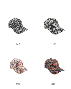Four digital print baseball caps with floral patterns including white and green flowers