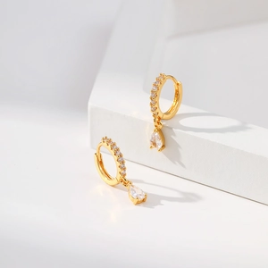 Elegant 18K gold brass teardrop earrings with clear zircon crystals on white stand