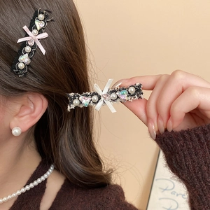Close-up of elegant lace hair clips with pearls and heart rhinestones on model's hair