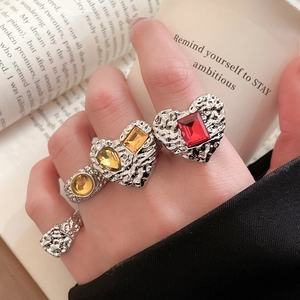 Macro shot of vintage style silver lava rings with colorful resin heart gemstones