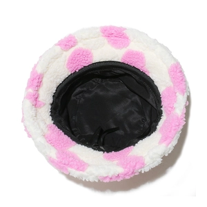 Top view detail of plush bucket hat with pink spots and black silky lining