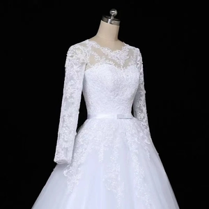 Elegant white long sleeve bridal gown with sheer lace embroidery and layered tulle skirt