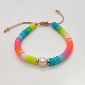 Detail of bohemian handmade beaded bracelet with natural pearl and adjustable cord