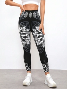Detailed view of high-waisted yoga pants with symmetric white mandala floral prints