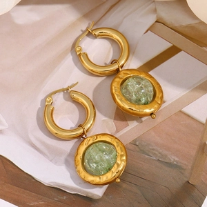 Detail of 18K gold plated earrings with hammered texture and green cracked glass beads