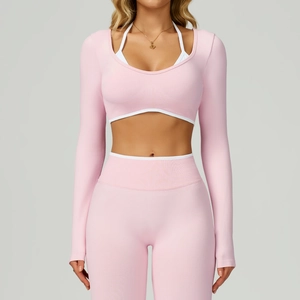 Detail of pink seamless long-sleeve crop top with white contrast edging for yoga