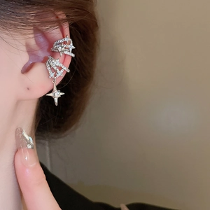 Close-up of silver multilayer star ear cuff with sparkling zircon and tassels on model