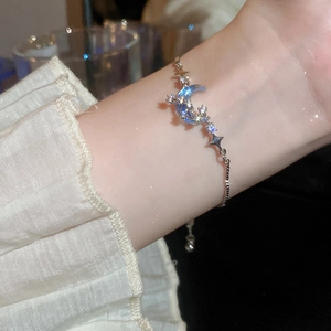 Close-up of silver adjustable moon and star bracelet with blue gradient stones