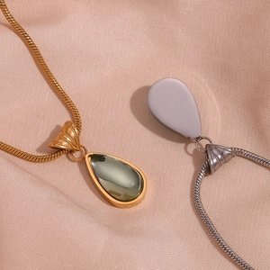 Chic gold and silver waterdrop necklaces with snake chains on elegant pink silk